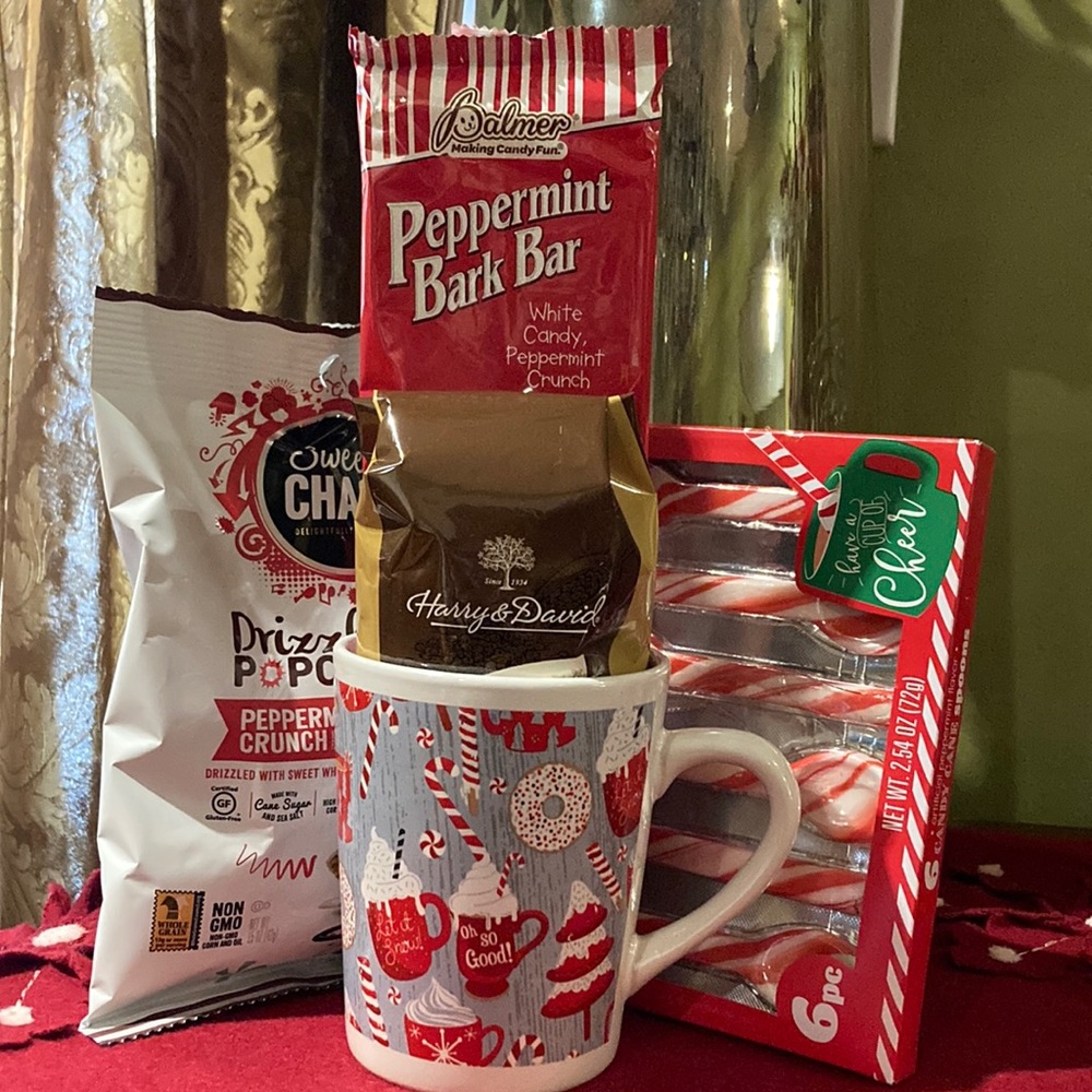 Harry & David ground coffee, peppermint bark, popcorn and spoons in ceramic mug.